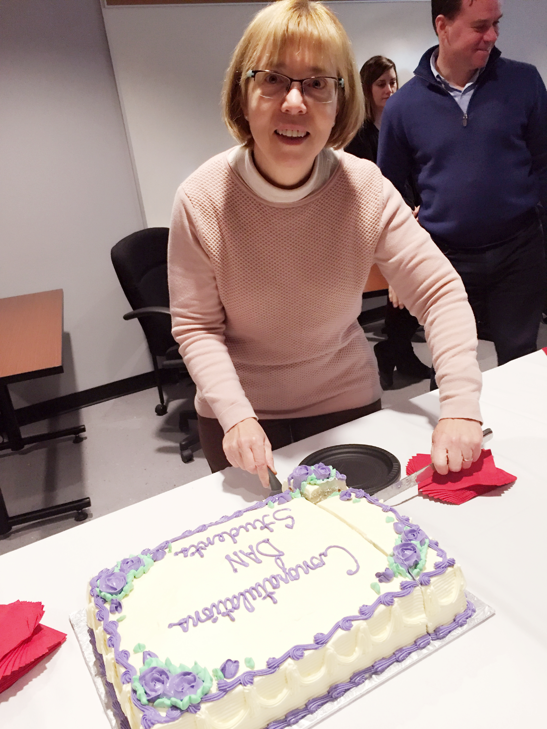 Emcee Ann Bigelow Cuts the cake
